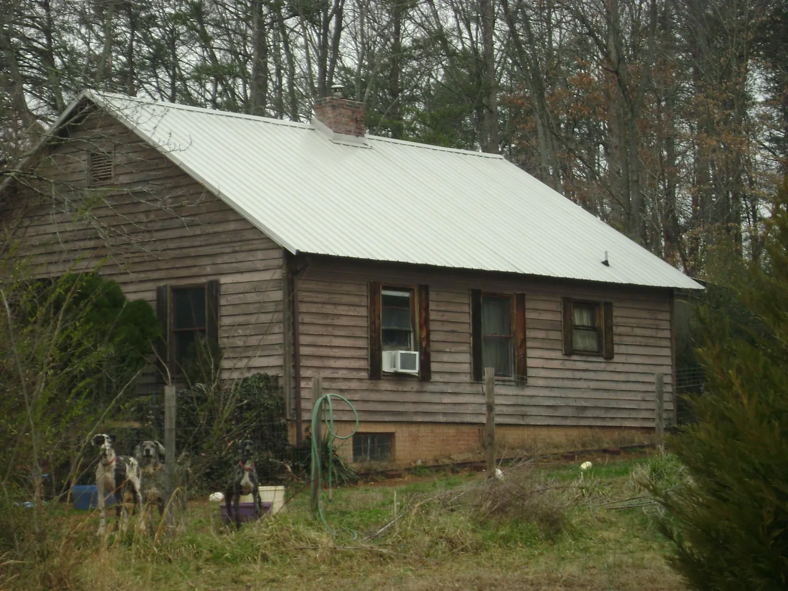 White metal roof on an old wood sided farmhouse, from a Metal Roof Installation job in Marble Rock